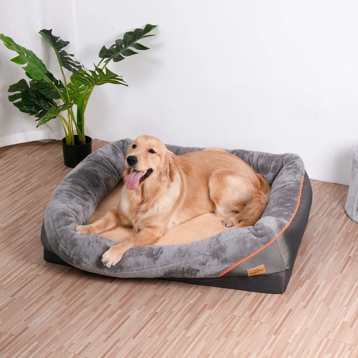 A dog resting on an orthopaedic foam dog bed with a Gray cover and orange detailing.