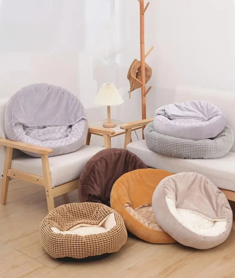 Collection of round pet beds in various colors on a wooden floor.