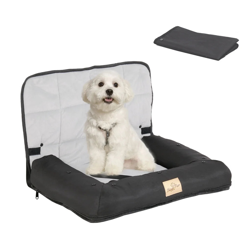 Black pet car seat with a white dog inside, folded black blanket on a white background