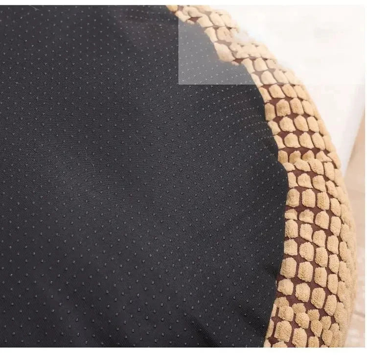 Close-up of a textured black surface with a woven beige border