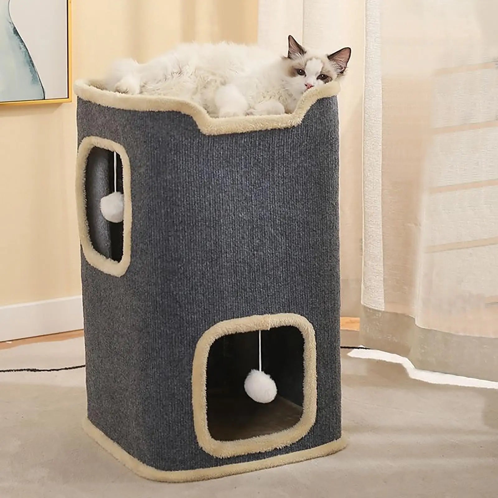 Cat playing with a blue and beige cat tree in a room.