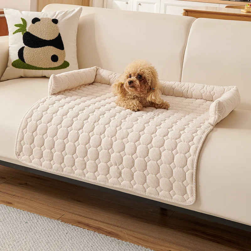 Dog lying on a quilted pet bed on a couch with a panda pillow in the background.