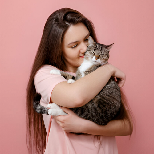 girl hugging cat